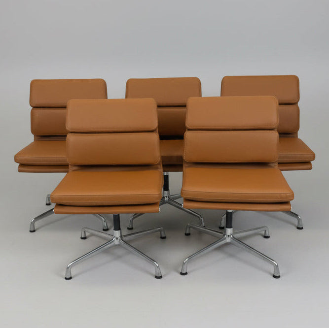 Set of brown office chairs with metal bases on a gray background